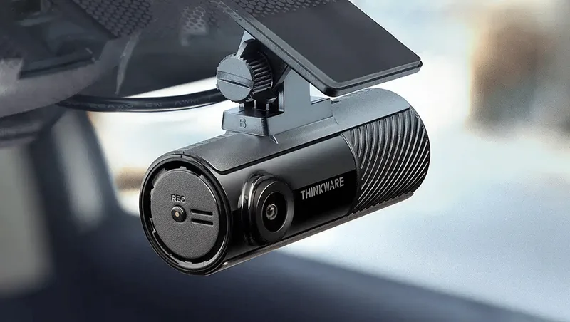Close-up of the Thinkware F70 Pro dashcam mounted behind a windscreen
